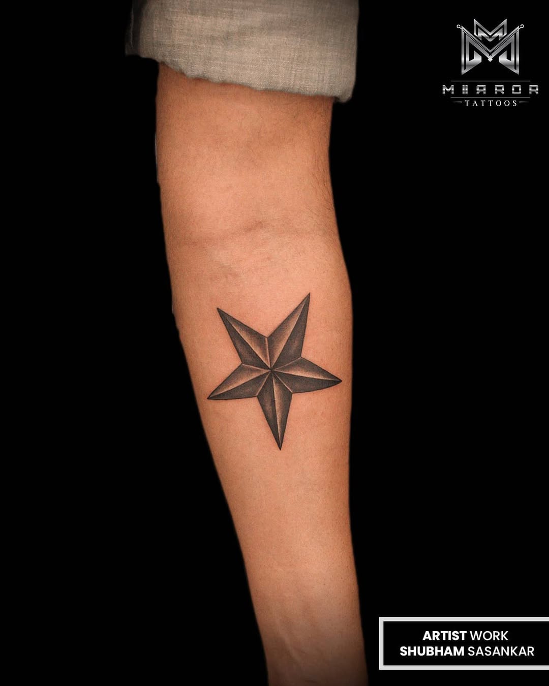 Elegant star tattoo on the forearm.