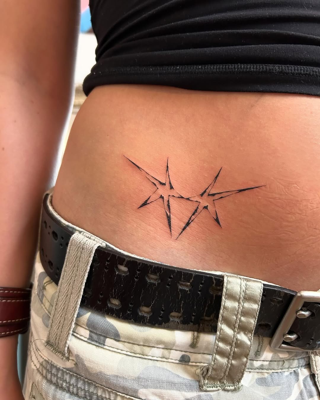 Minimalist star tattoo design on the hip