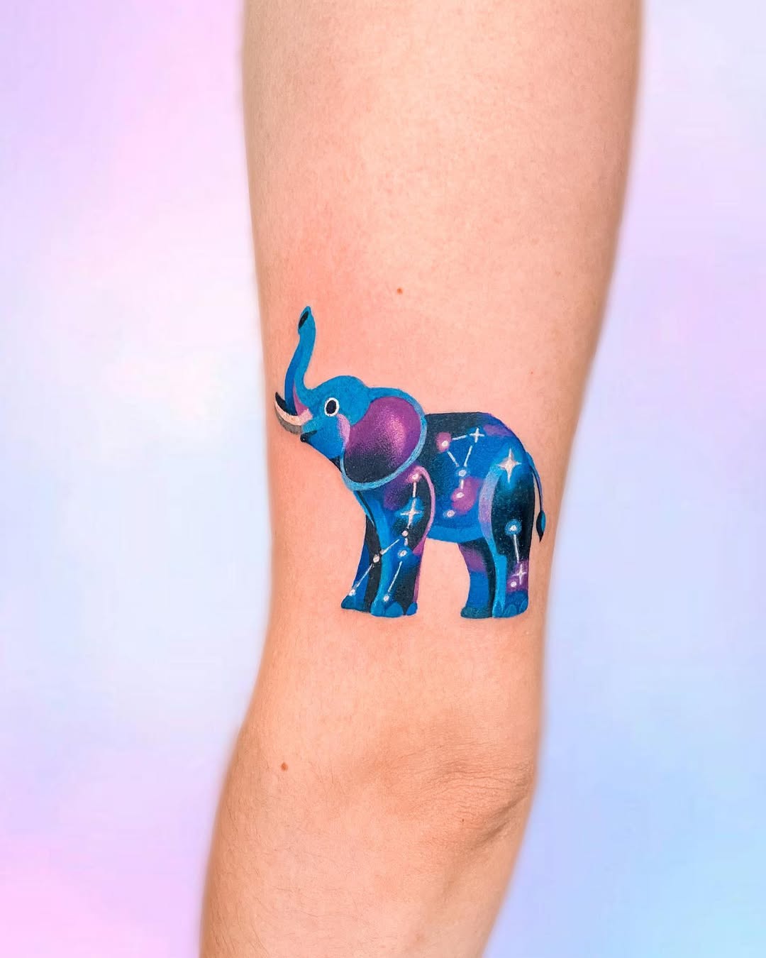 Vibrant elephant tattoo showcasing cosmic themes