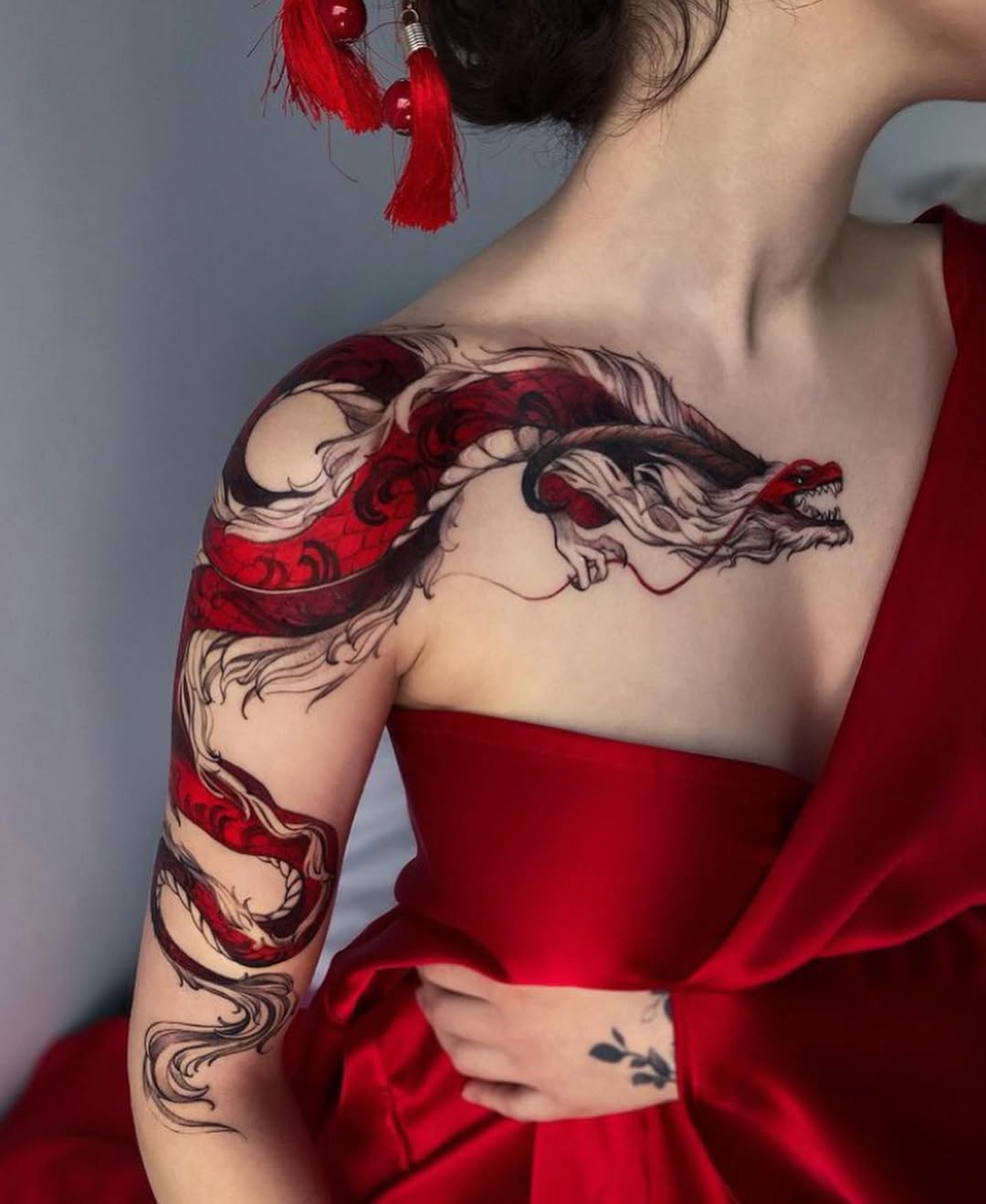 Intricate red and black dragon tattoo design