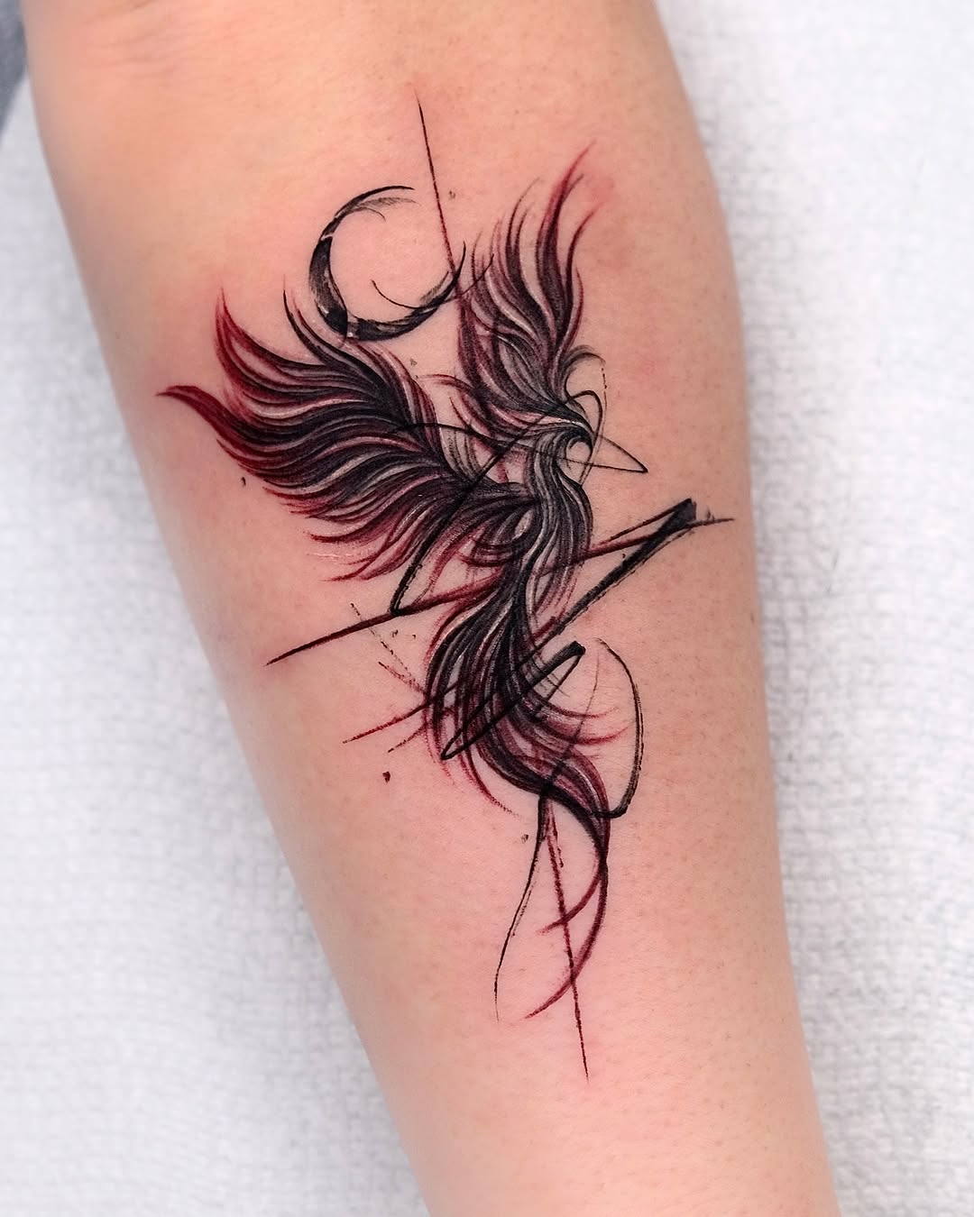 Elegant phoenix tattoo with striking red accents