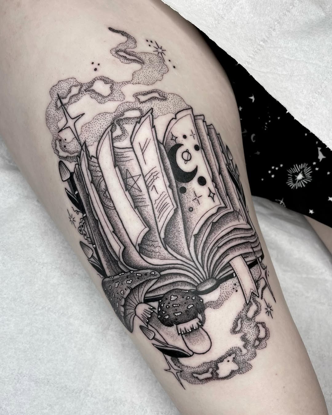 Intricate tattoo showcasing a mystical open book