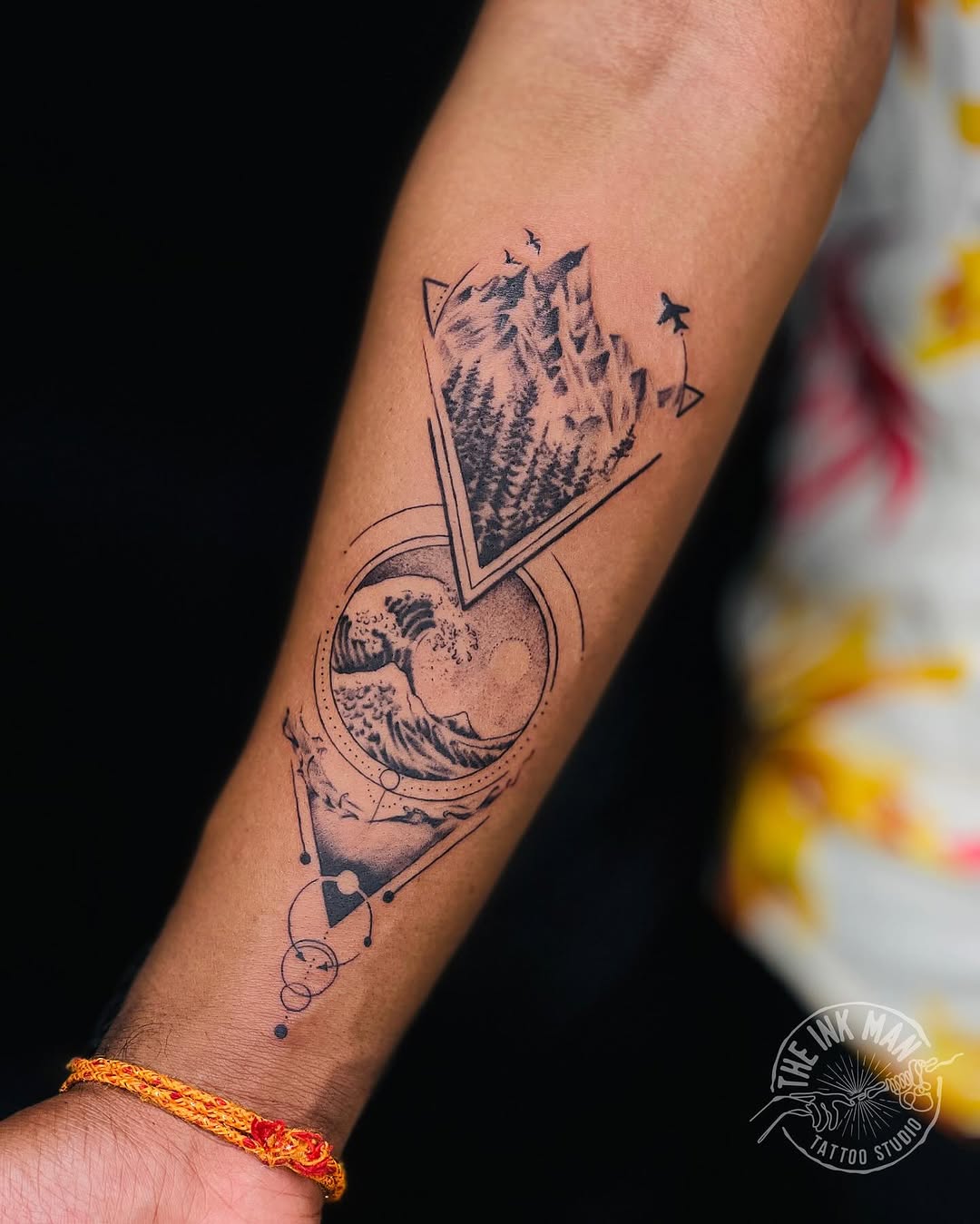 Stunning mountain and wave travel tattoo design