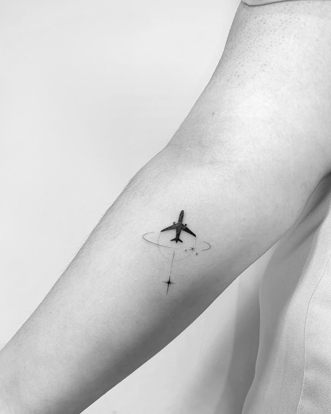 Minimalist airplane tattoo for wanderlust souls