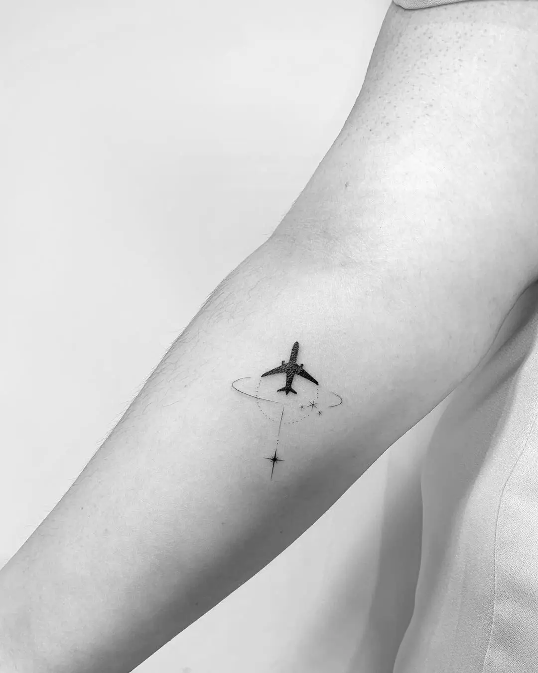 Minimalist airplane tattoo for wanderlust souls