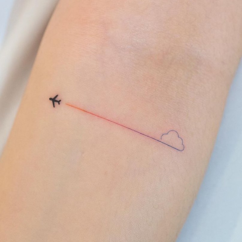 Minimalist airplane tattoo with a cloud