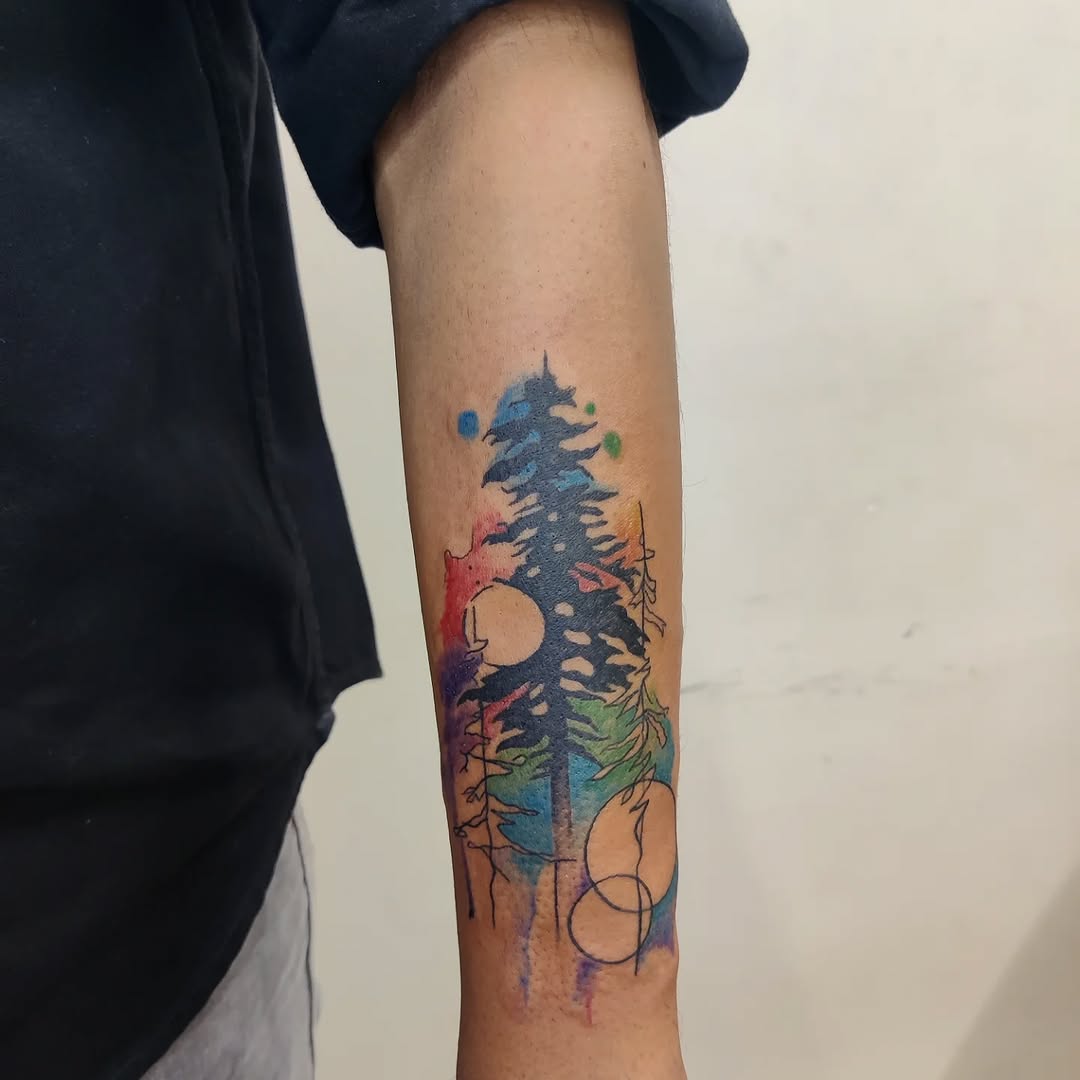 Vibrant forest silhouette tattoo with watercolor effects