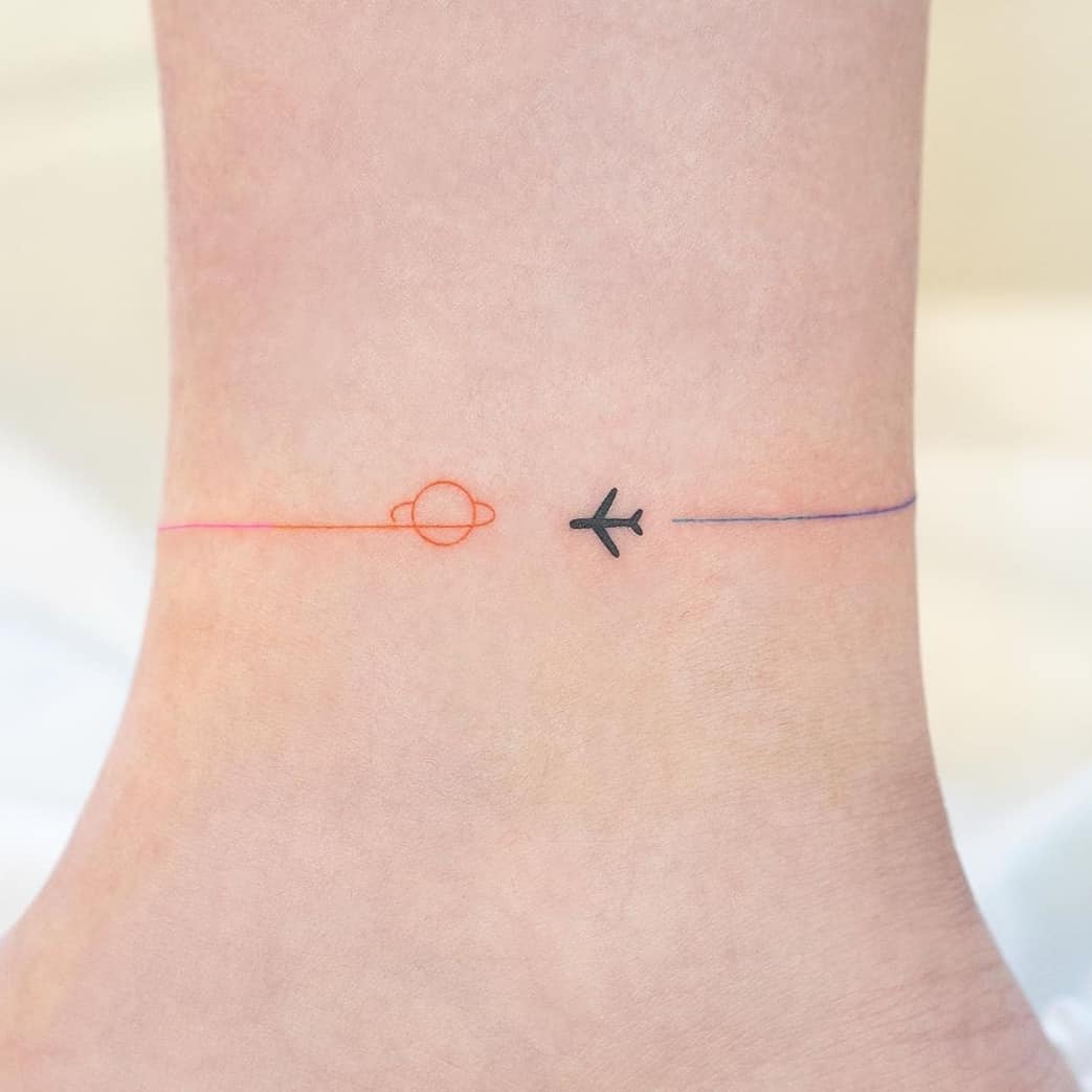 Minimalist tattoo celebrating travel and adventure