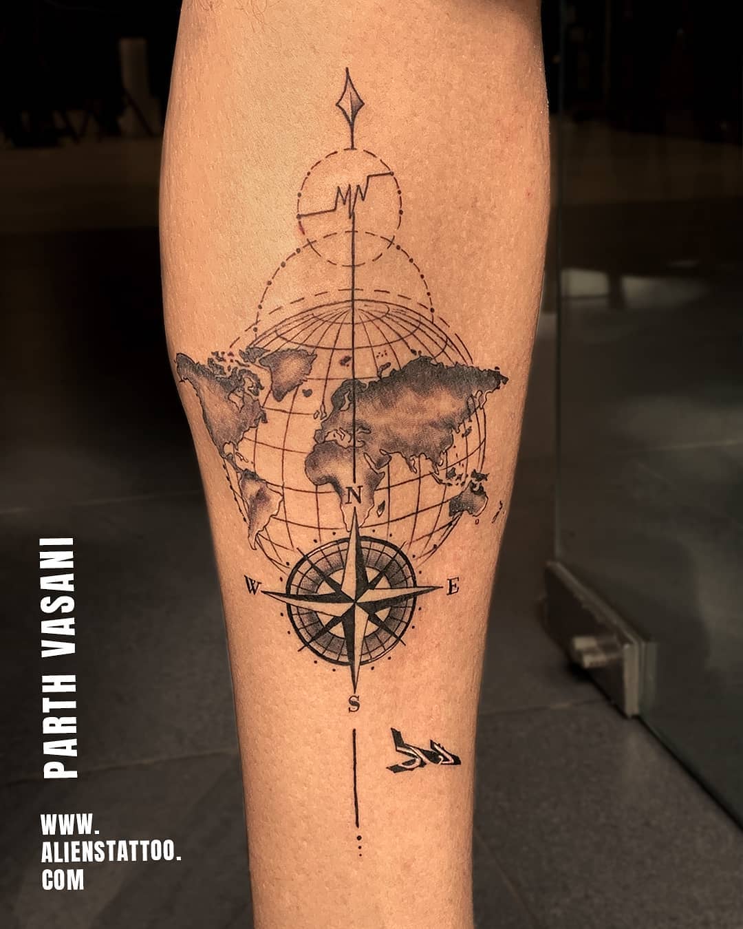 Adventure-inspired compass and world map tattoo