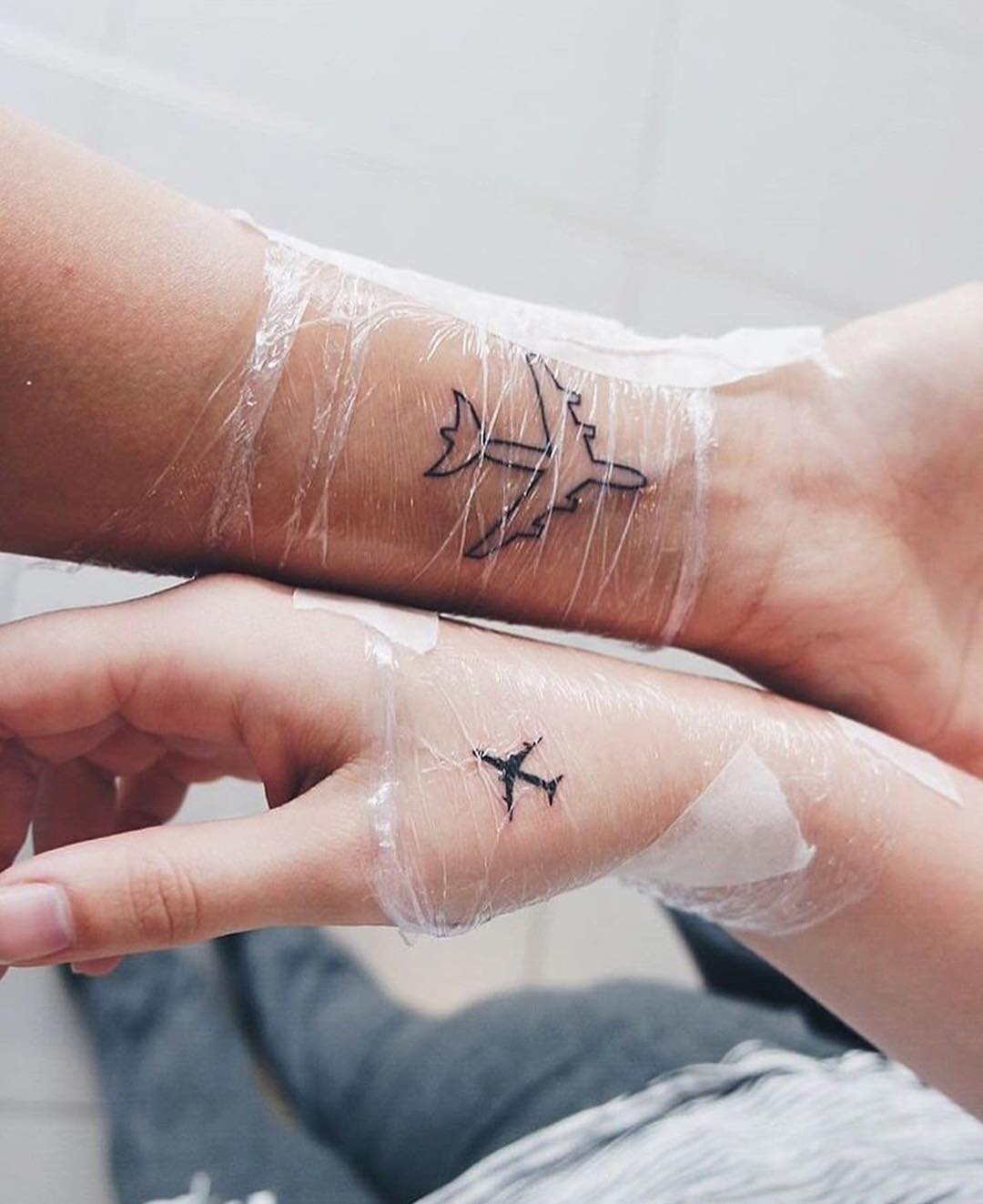 Symbolic tattoos celebrating travel and friendship