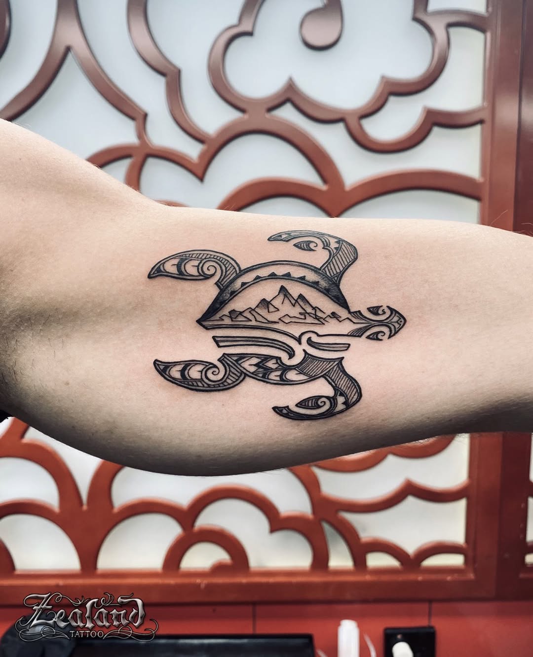 Tribal turtle tattoo with ocean wave elements