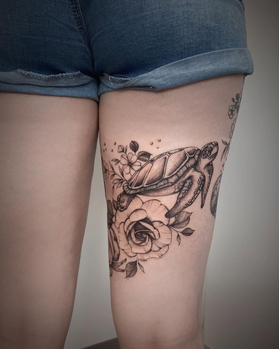 Beautiful turtle tattoo embellished with flowers