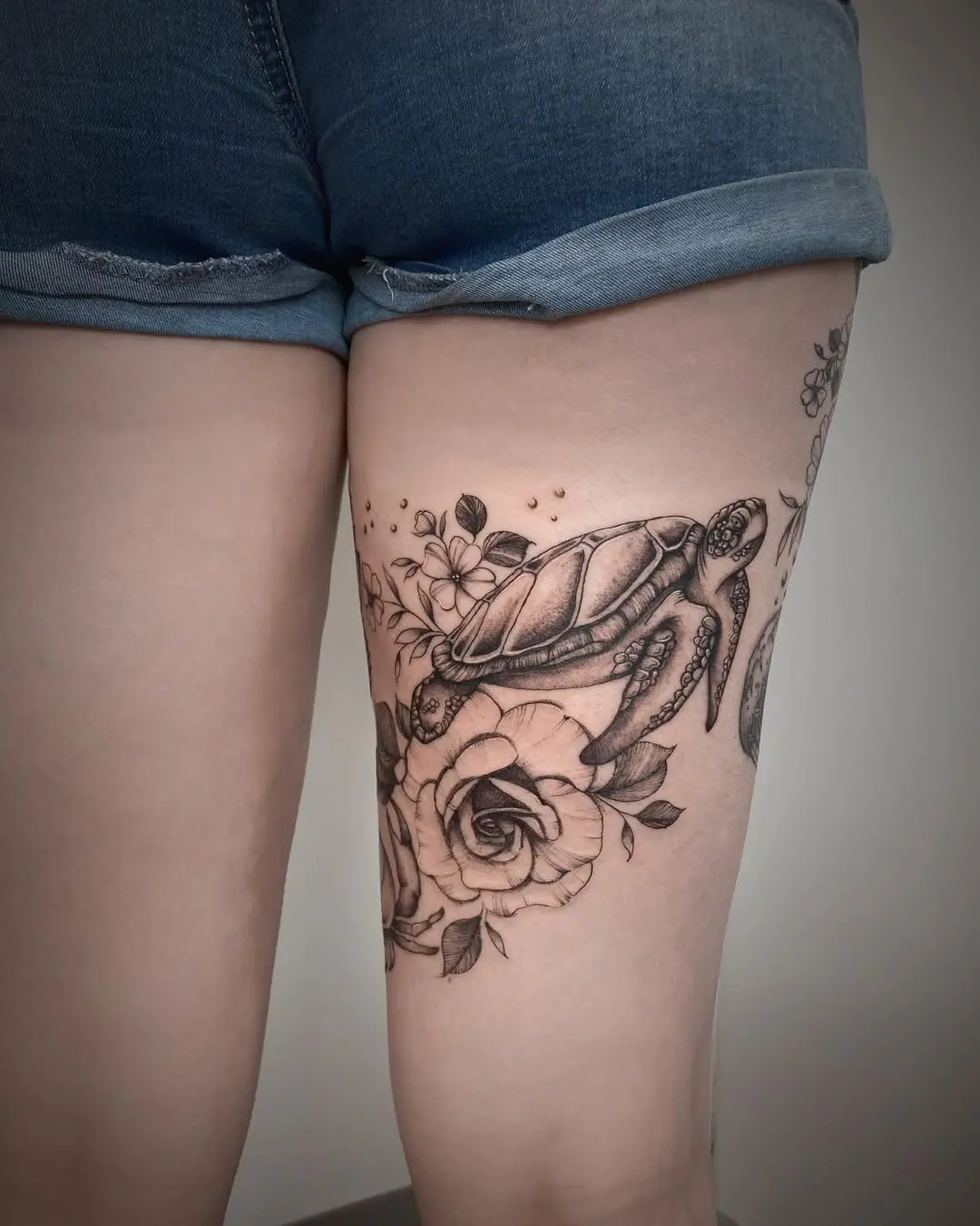 Beautiful turtle tattoo embellished with flowers