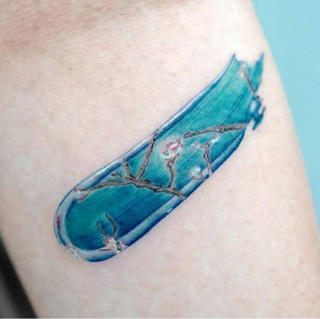 Elegant blue floral tattoo with Van Gogh influence