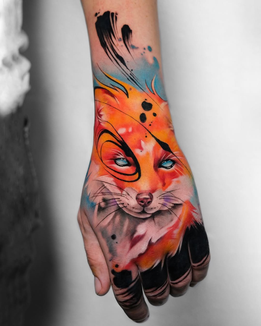 Stunning hand tattoo showcasing a colorful fox