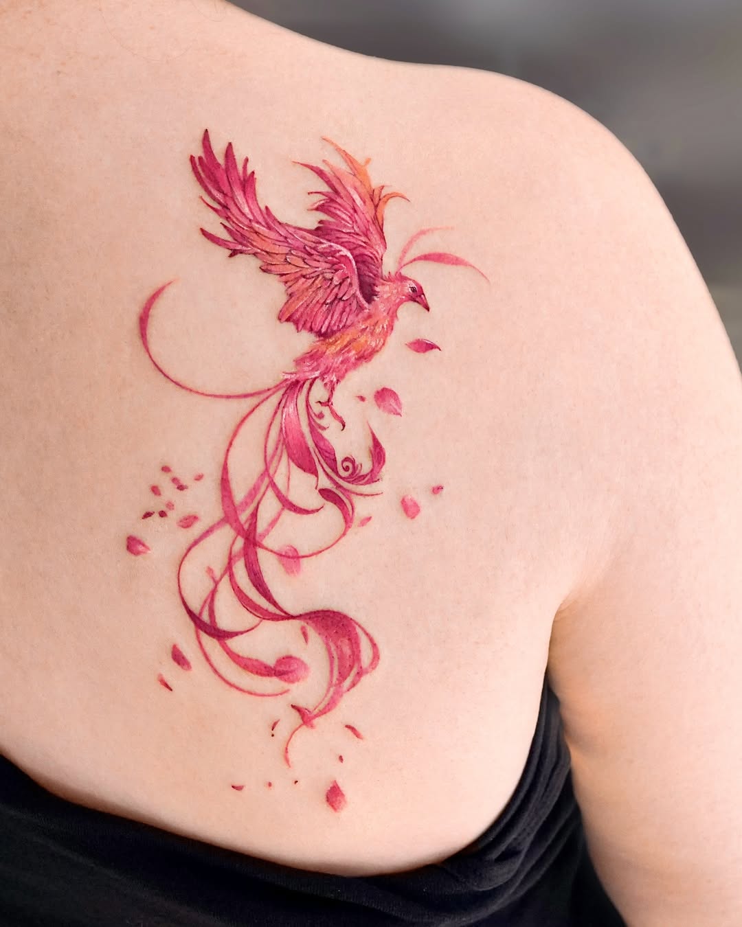 Stunning pink phoenix tattoo with flowing designs