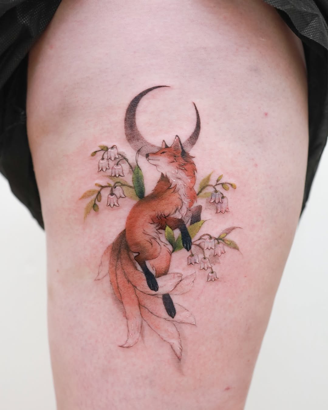 Dreamy fox tattoo with moon and flowers