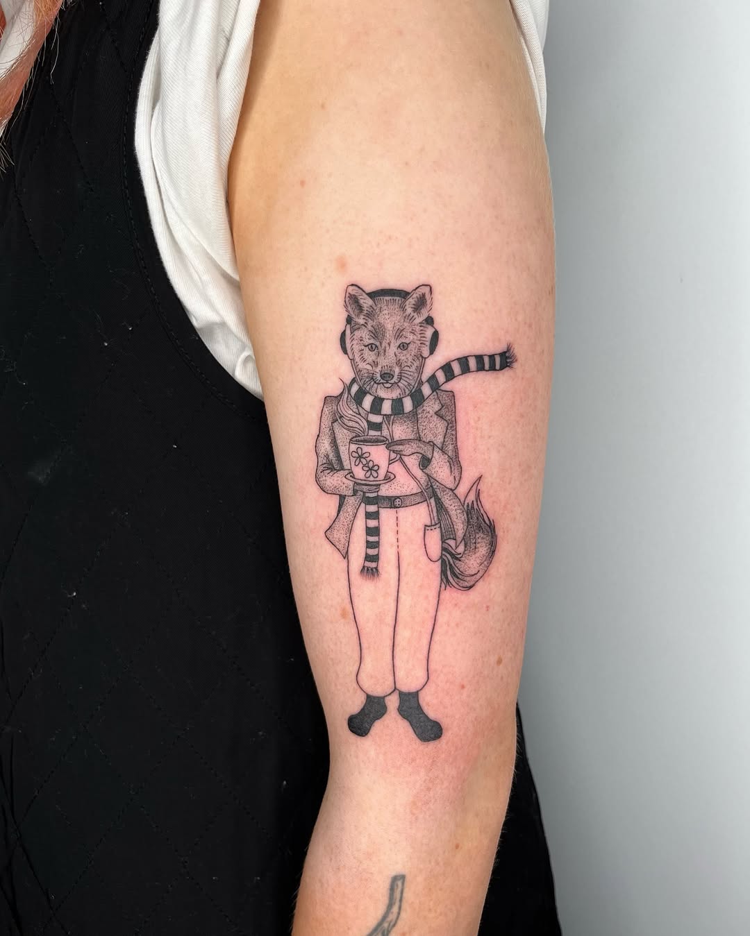 Charming fox tattoo in stylish winter attire