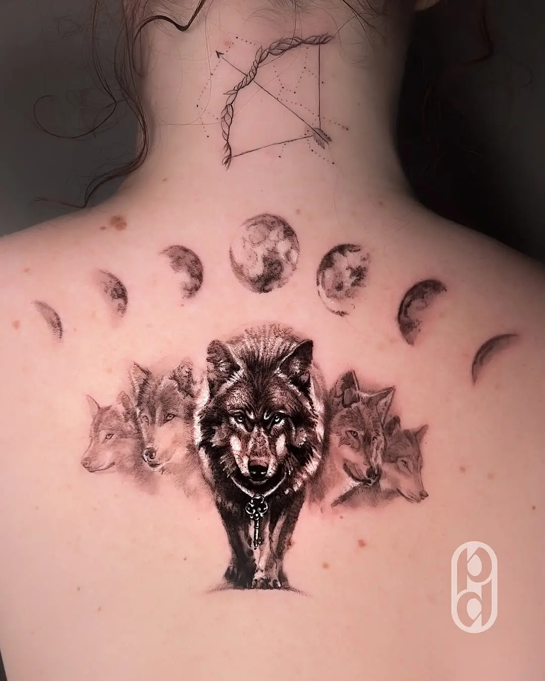 Intricate Sagittarius tattoo featuring wolves and moons