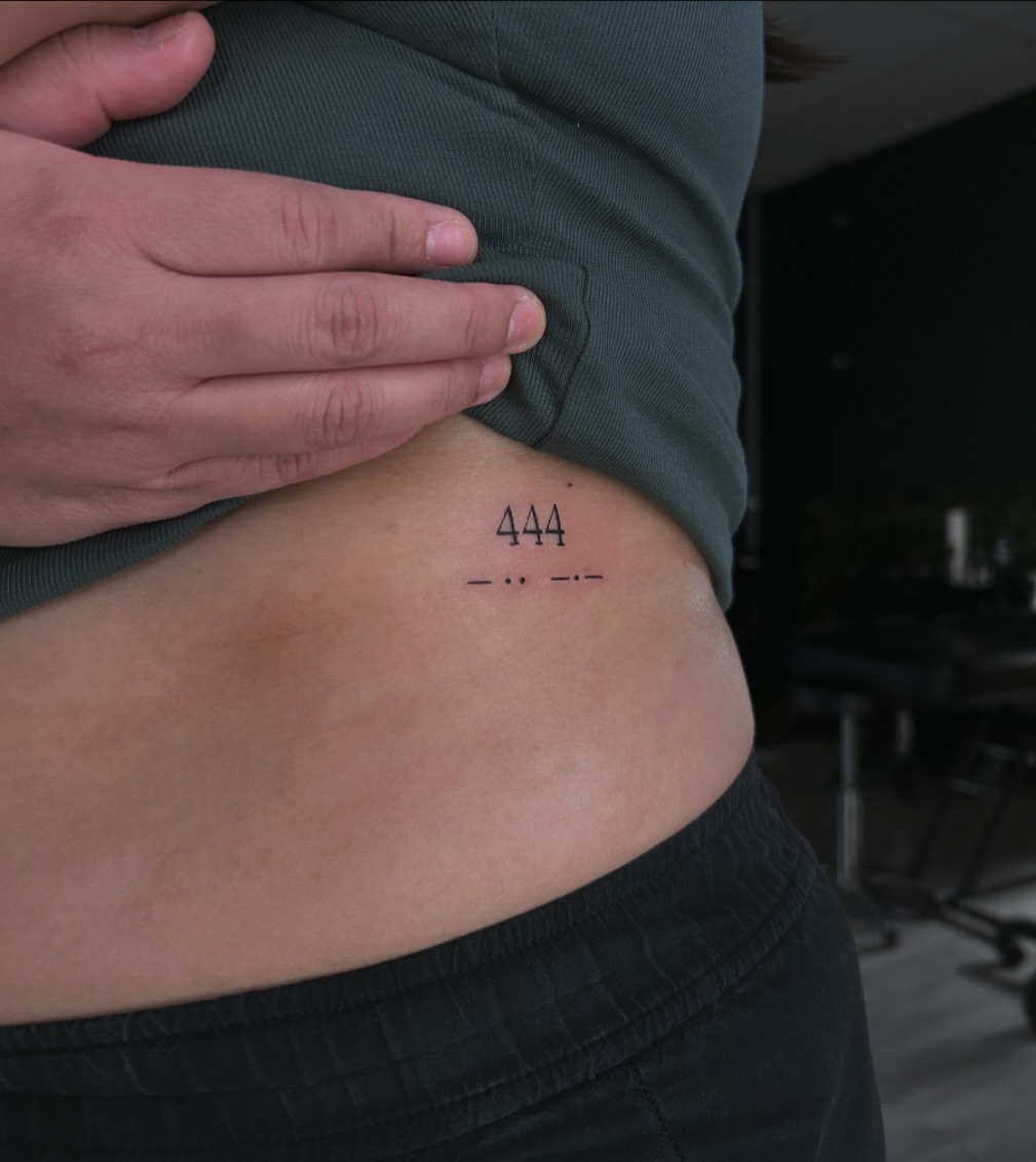 Elegant tattoo showcasing angel number 444