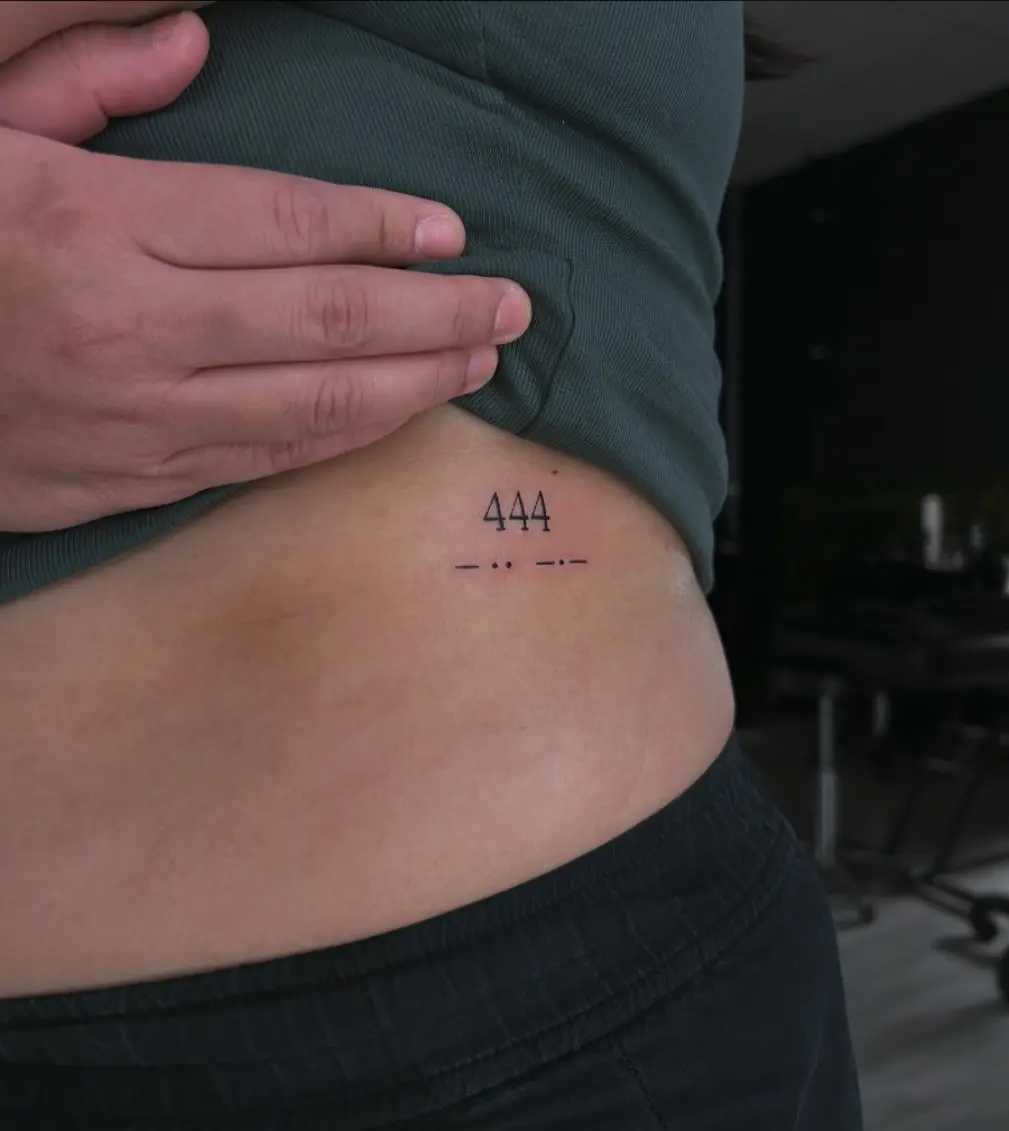 Elegant tattoo showcasing angel number 444