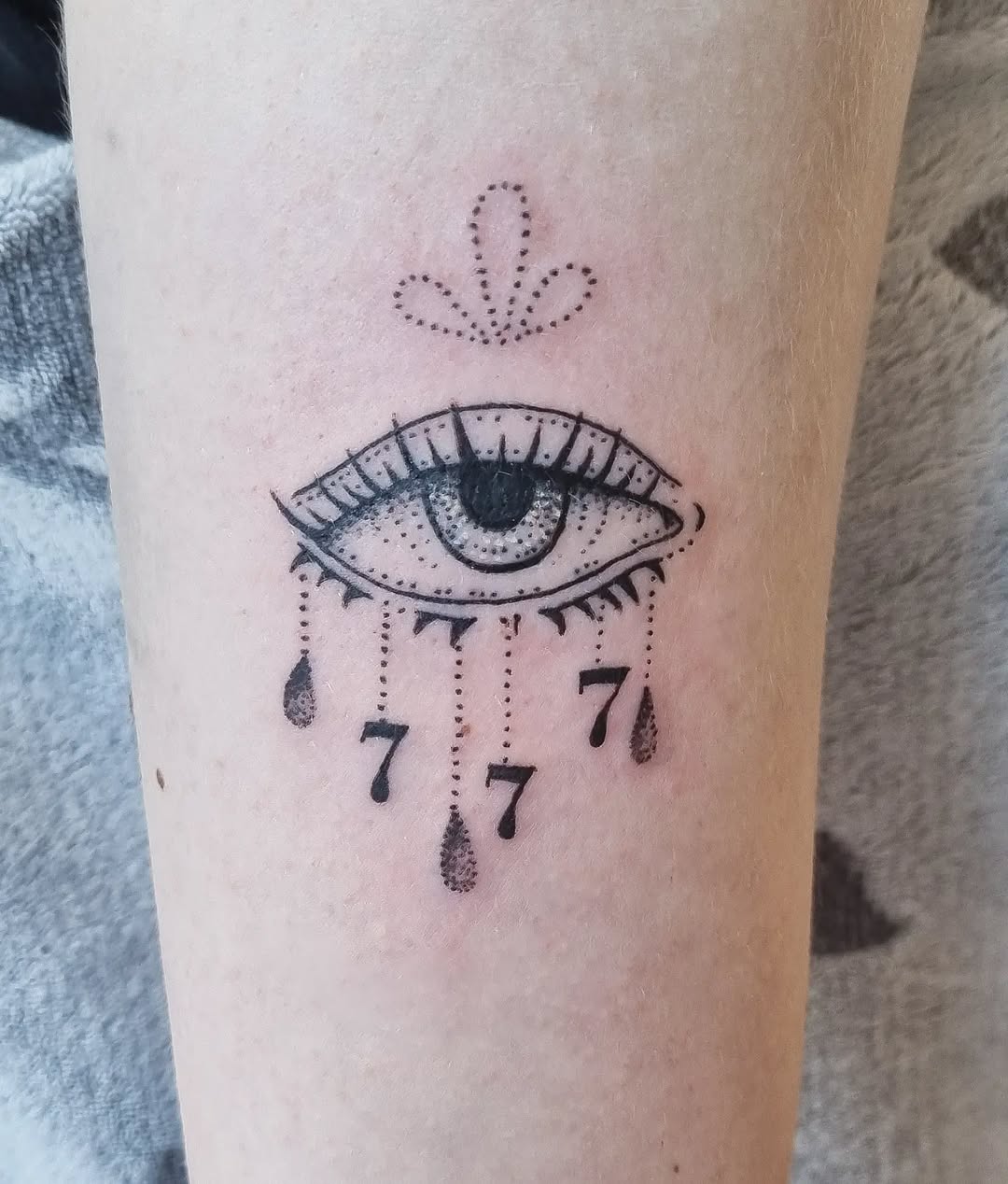 Mystical eye tattoo with angel number seven