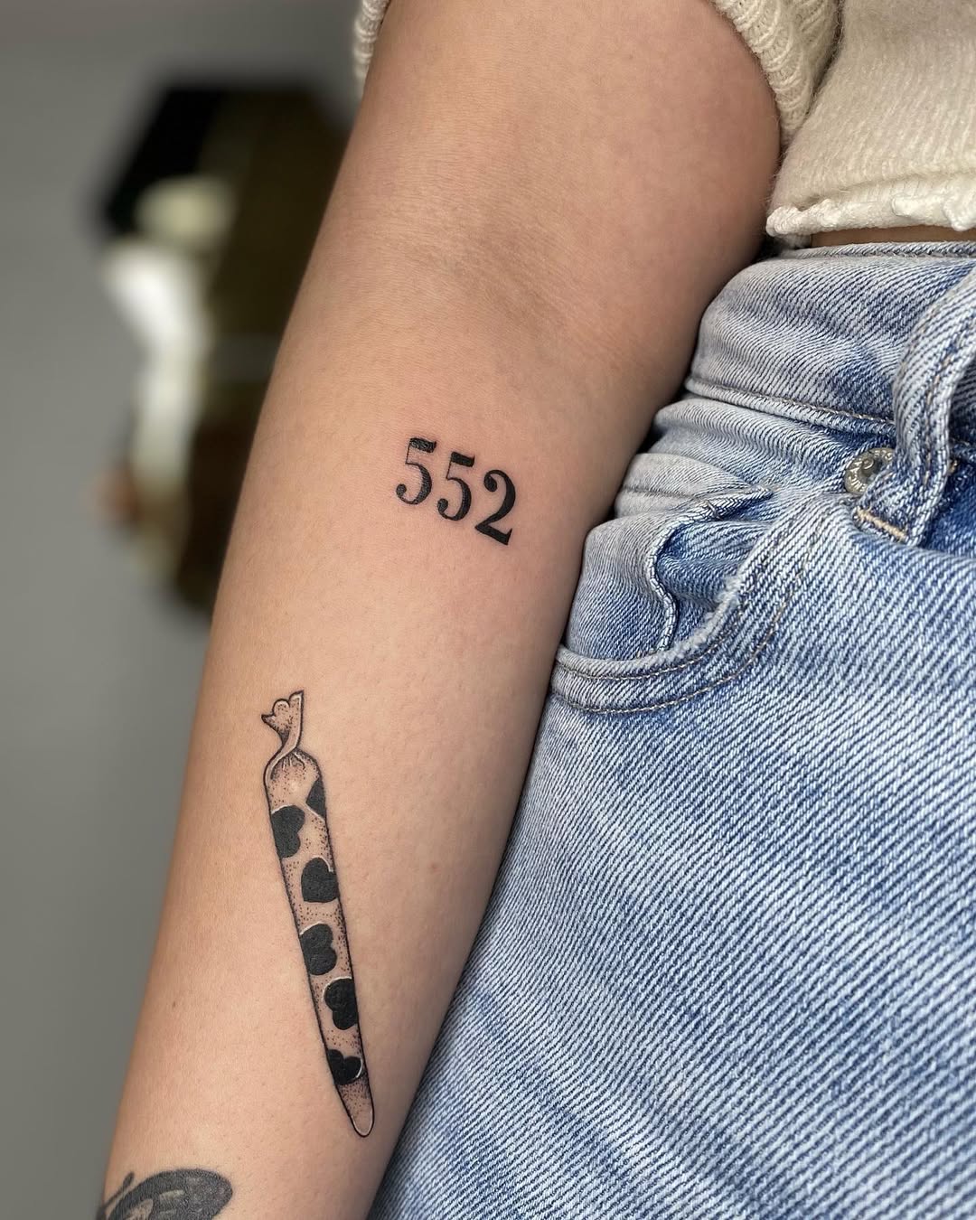 Stylish 552 angel number tattoo design