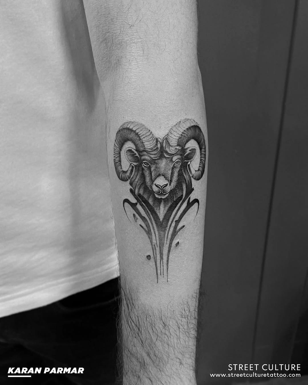 Intricate ram head tattoo with floral accents