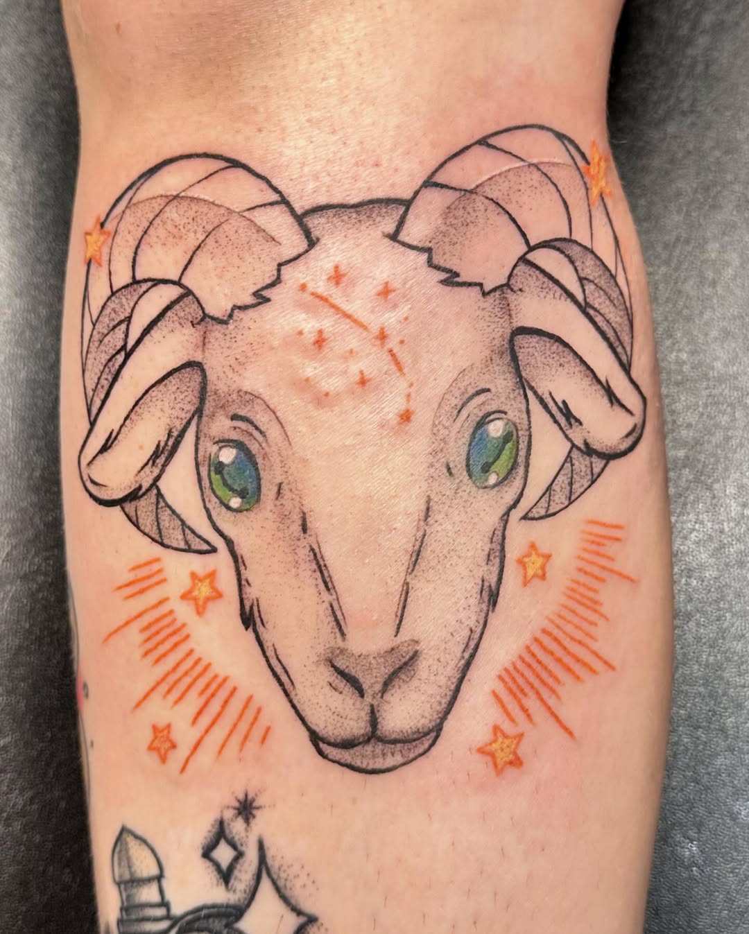 Eye-catching Aries ram tattoo with cosmic elements