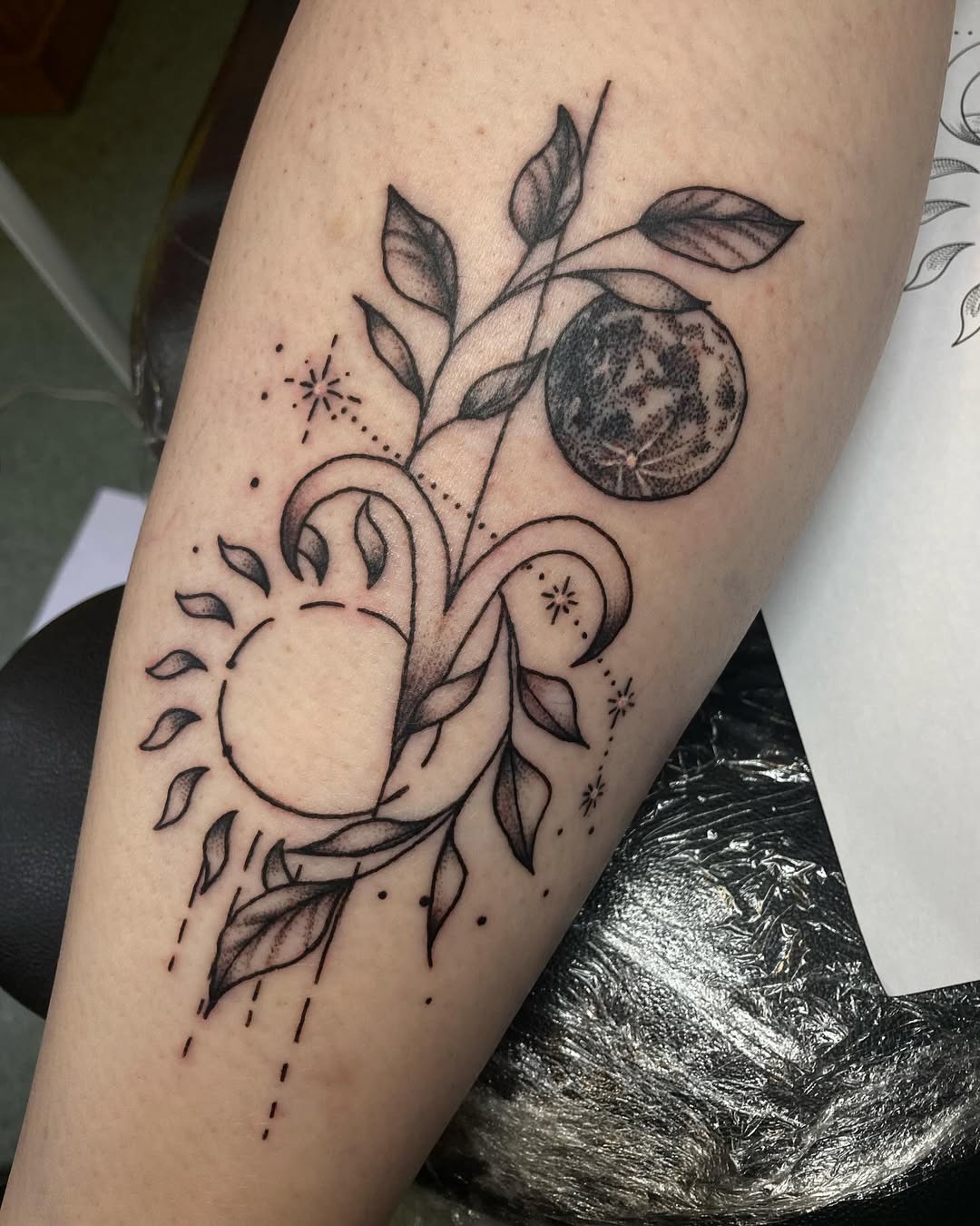 Elegant moon and sun Aries-inspired tattoo design