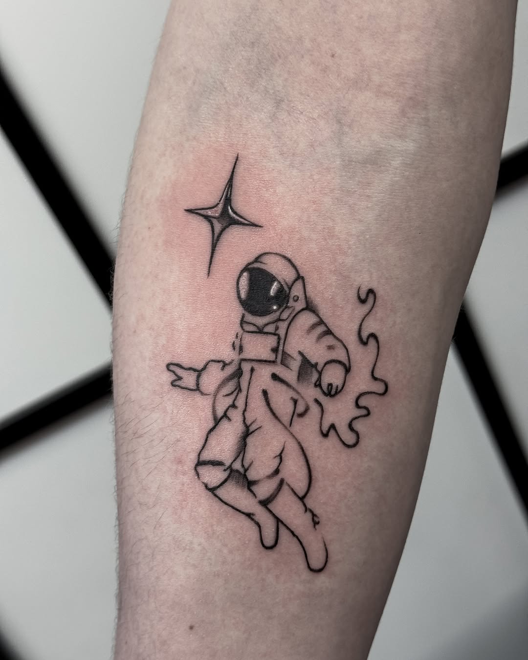 Charming astronaut tattoo exuding playful vibes