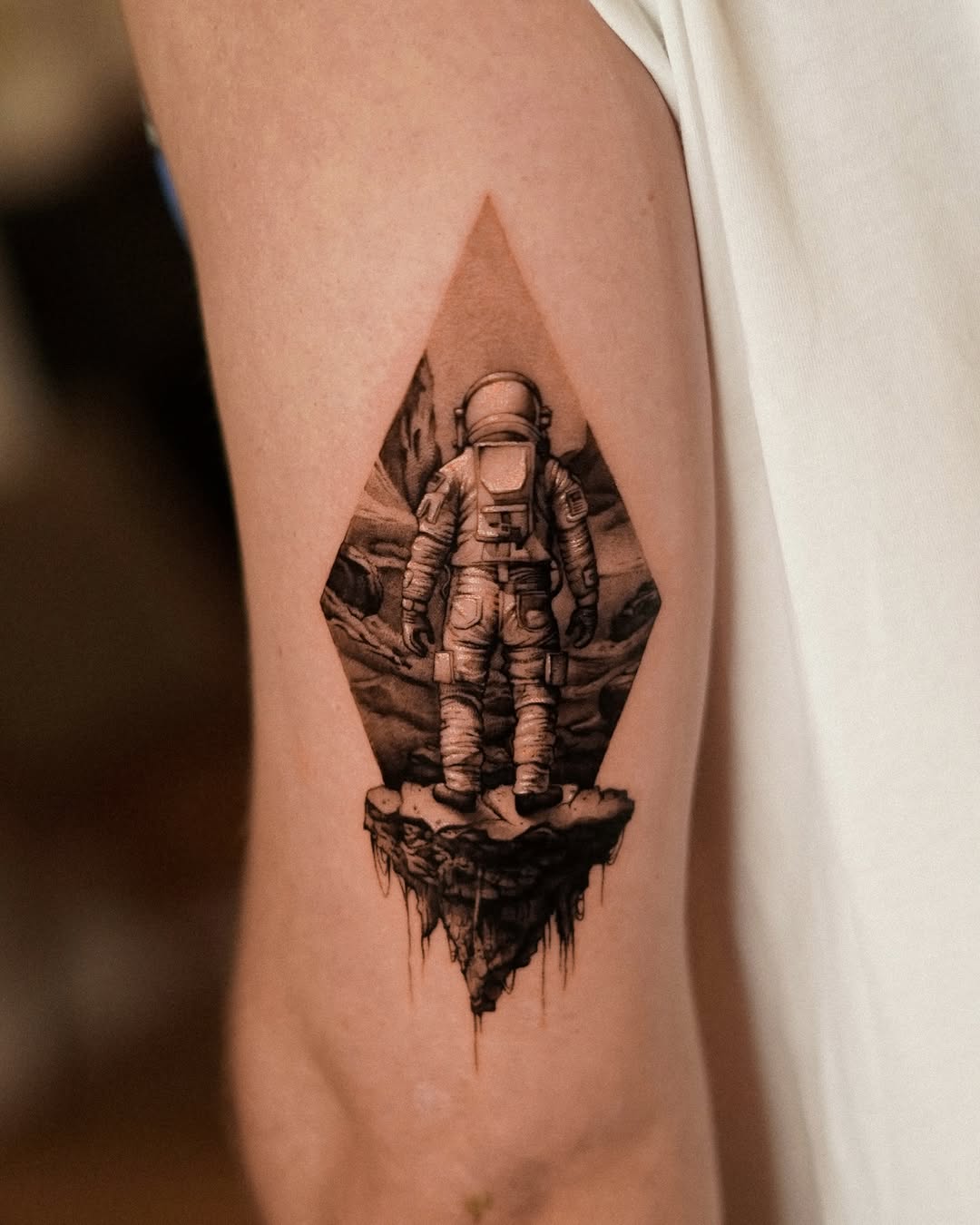 Stunning astronaut tattoo in a cosmic setting