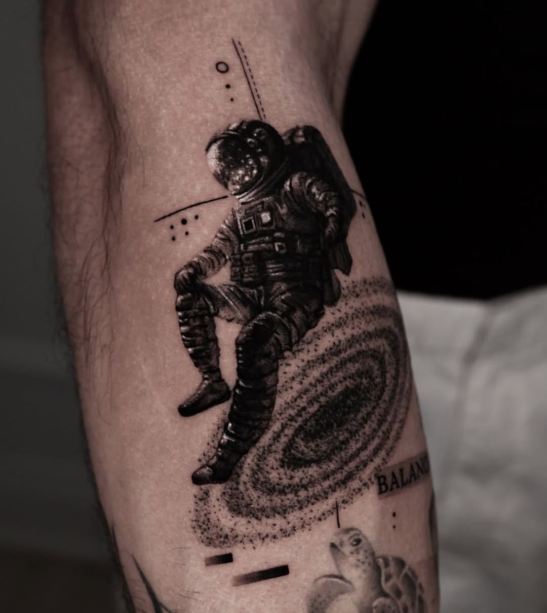 Astronaut tattoo capturing cosmic serenity and balance.