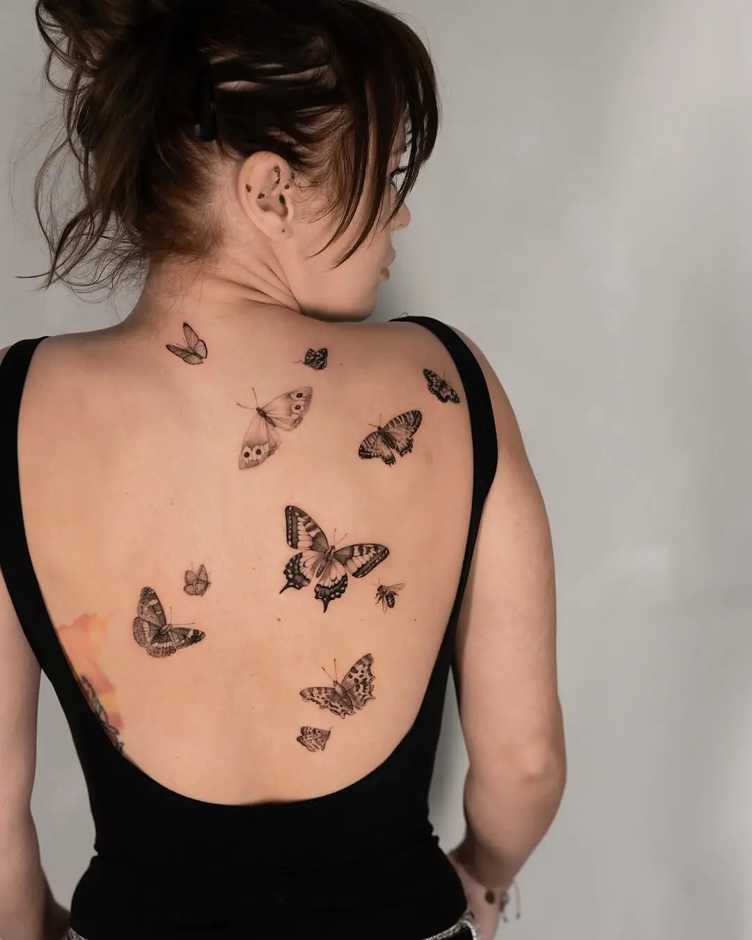Elegant butterflies adorn a woman's back beautifully