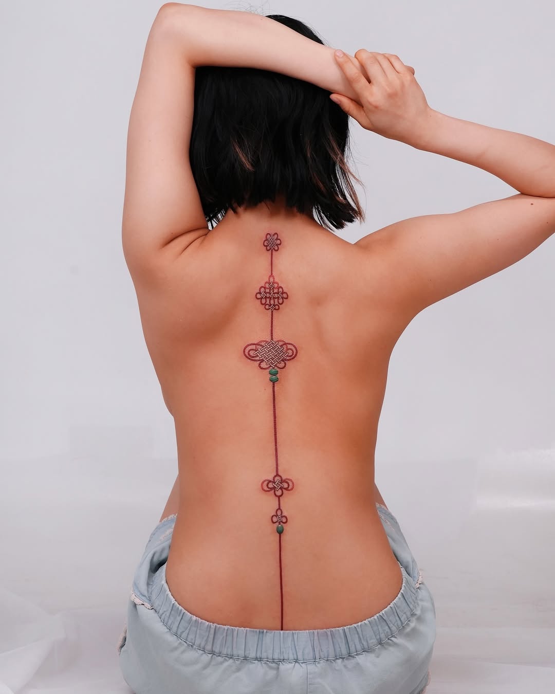 Elegant geometric floral back tattoo for women