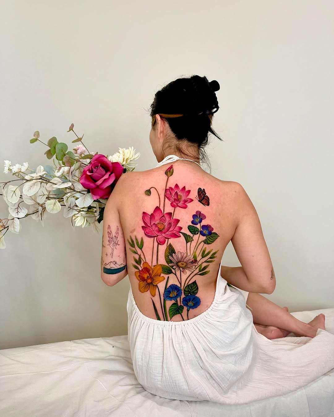 Vibrant floral back tattoo design for women