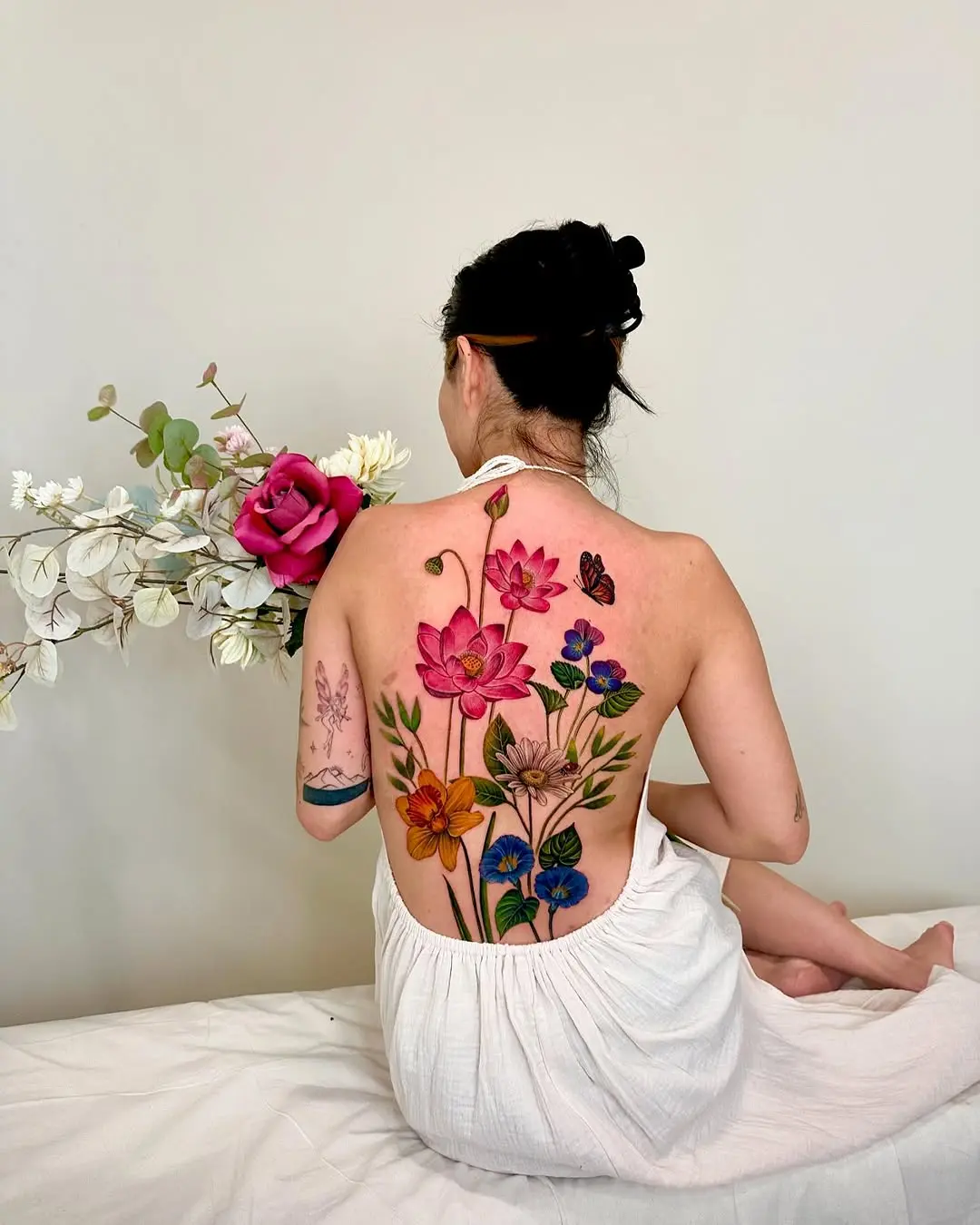 Vibrant floral back tattoo design for women