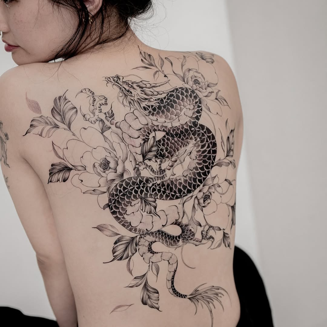 Intricate dragon and floral back tattoo design