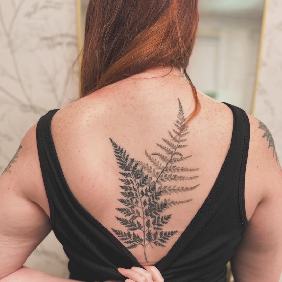 Elegant fern tattoo gracing the back