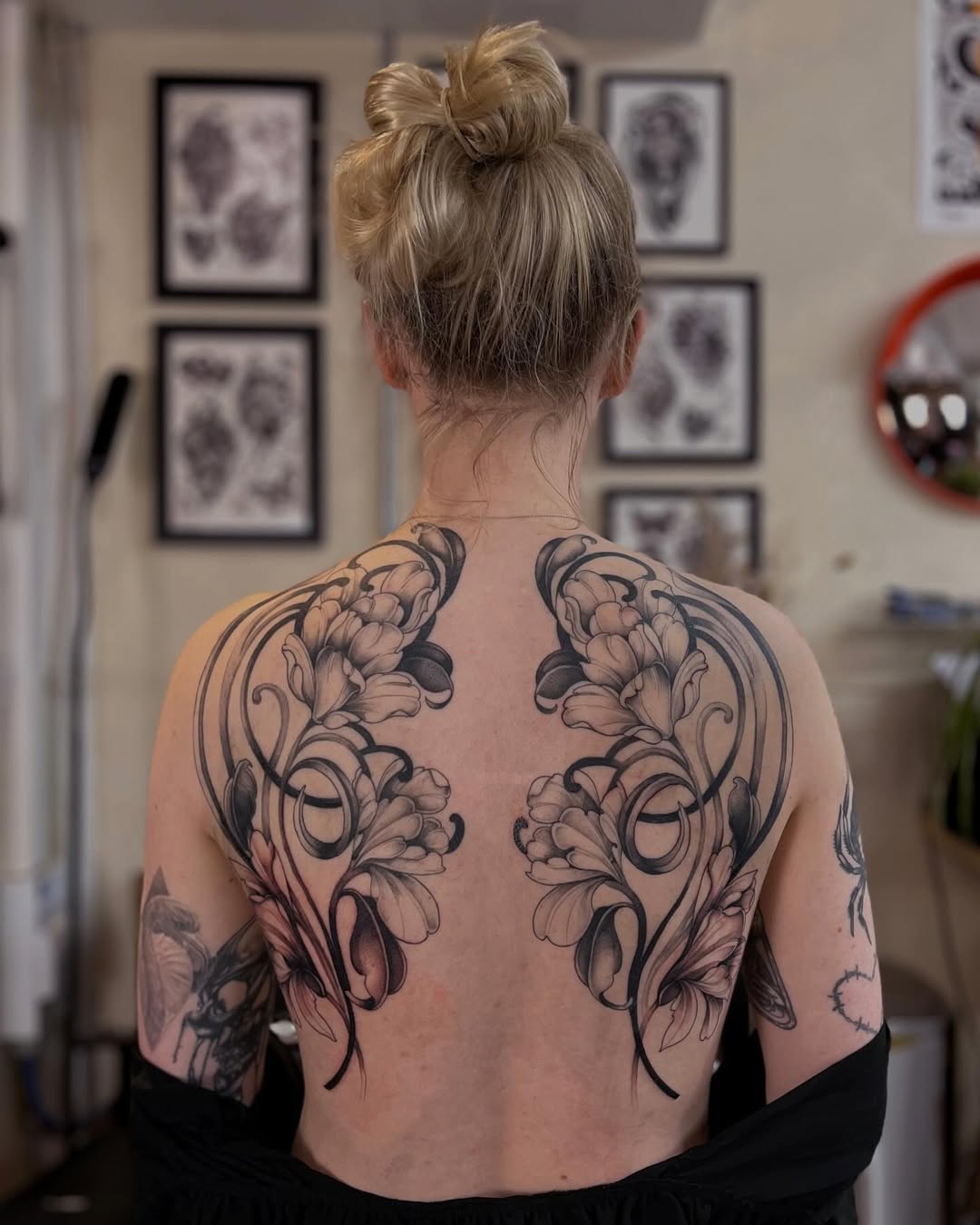 Elegant floral back tattoo for women