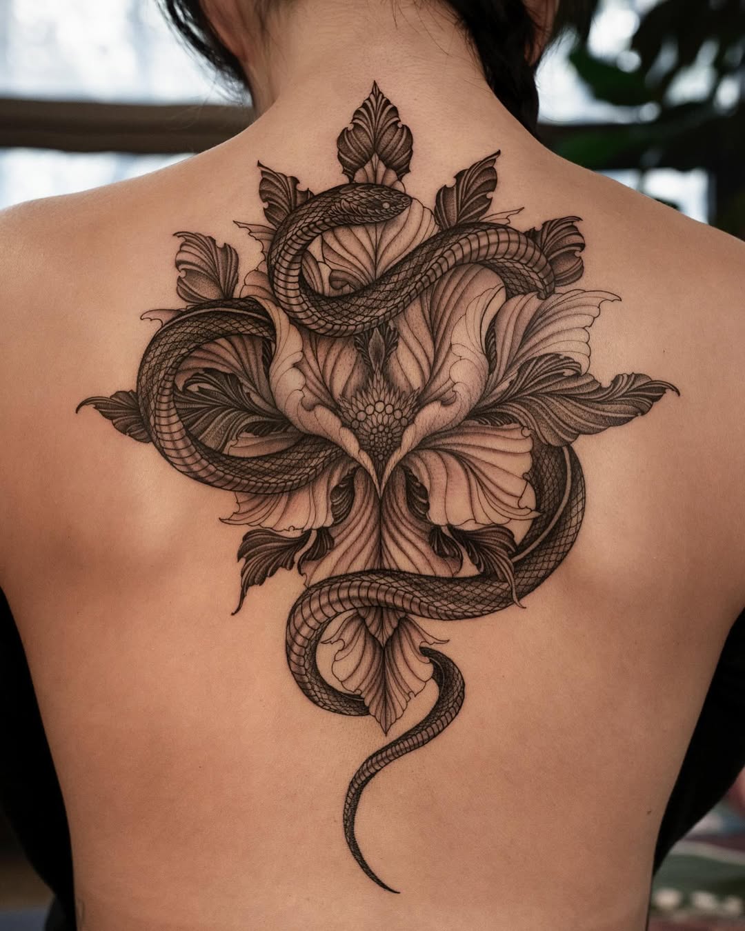 Elegant snake and floral back tattoo design