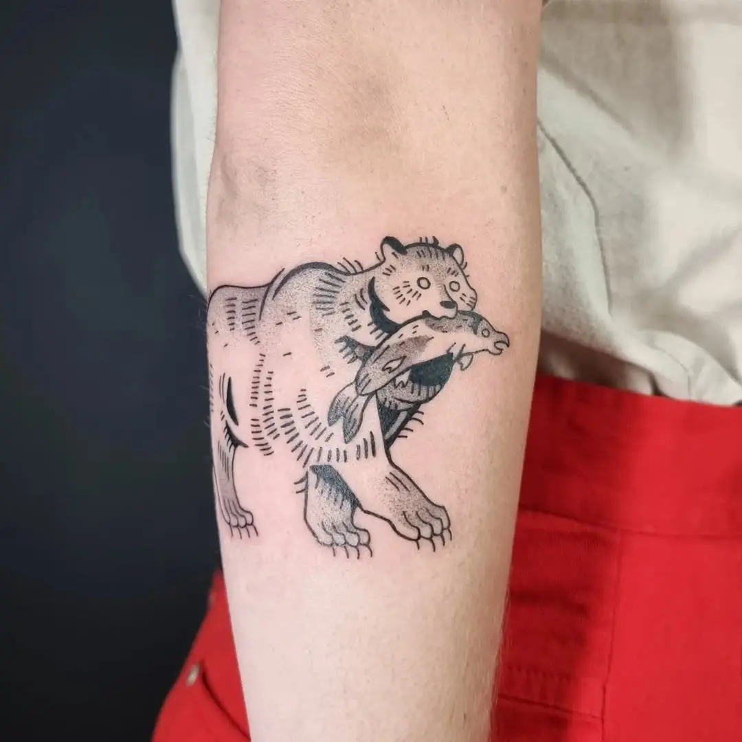 Stylish bear tattoo with a catch of fish