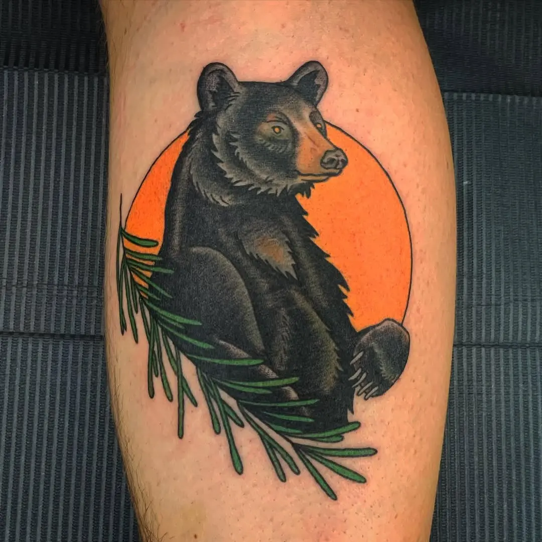 Majestic bear tattoo with sunset backdrop