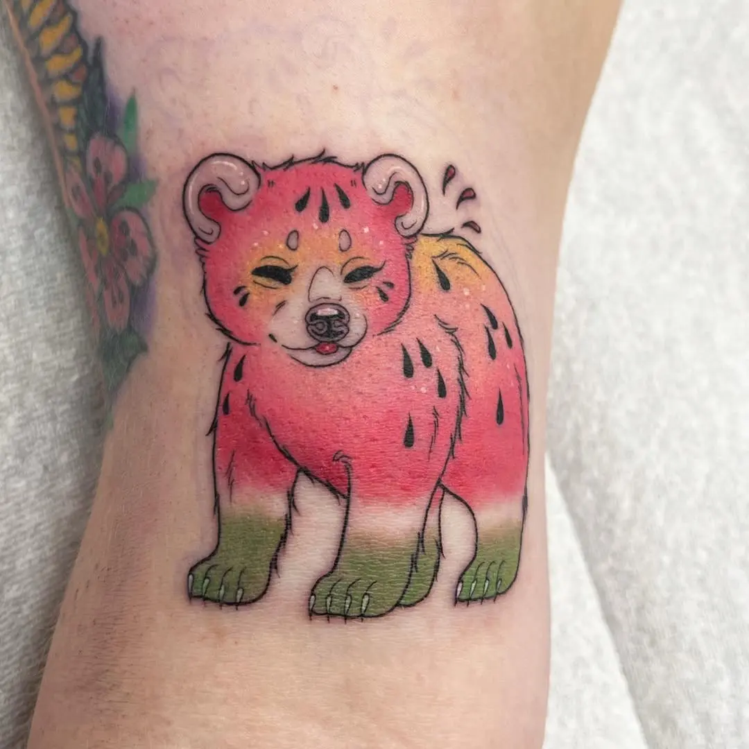 Whimsical bear tattoo with a fruity twist
