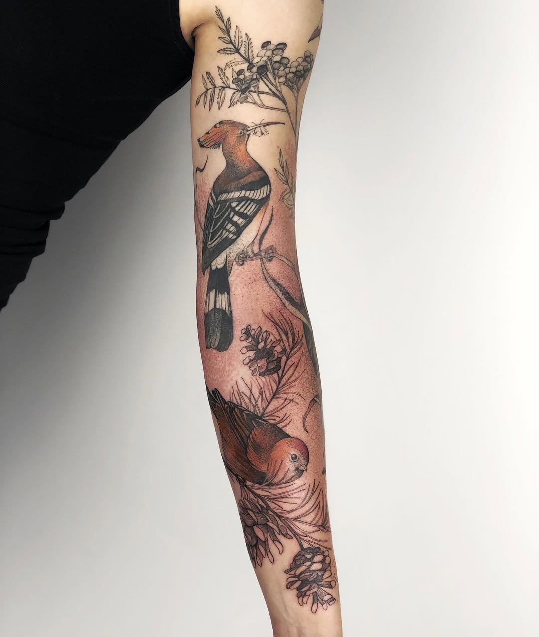 Elegant bird-themed floral sleeve tattoo design