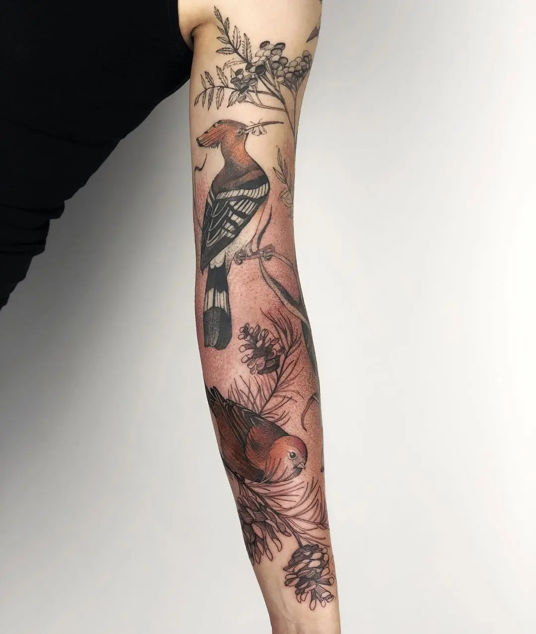 Elegant bird-themed floral sleeve tattoo design