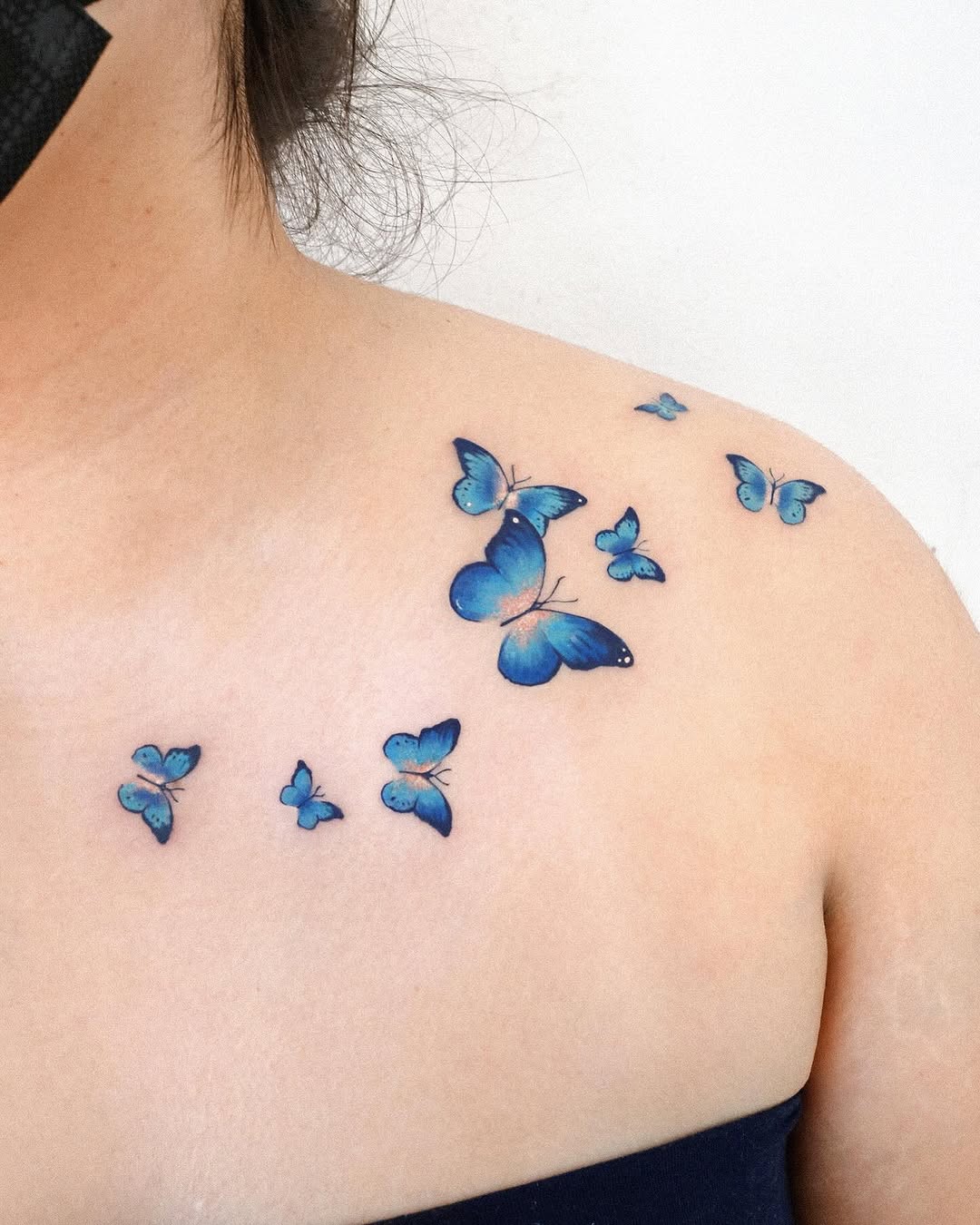 Elegant blue butterfly tattoos on the shoulder