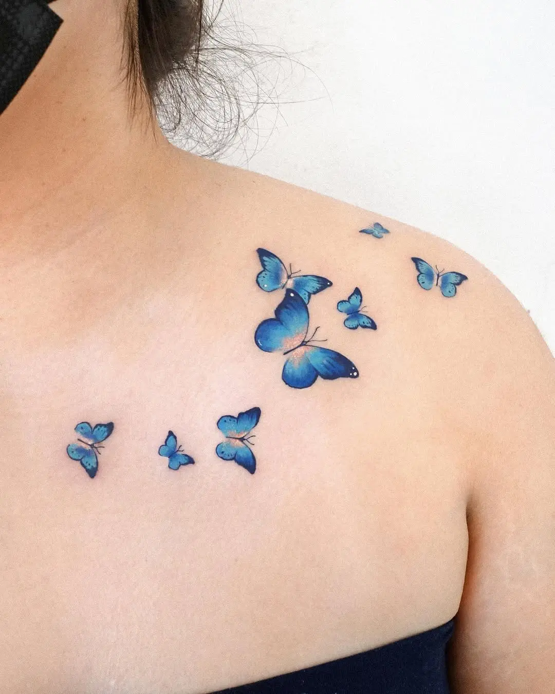 Elegant blue butterfly tattoos on the shoulder