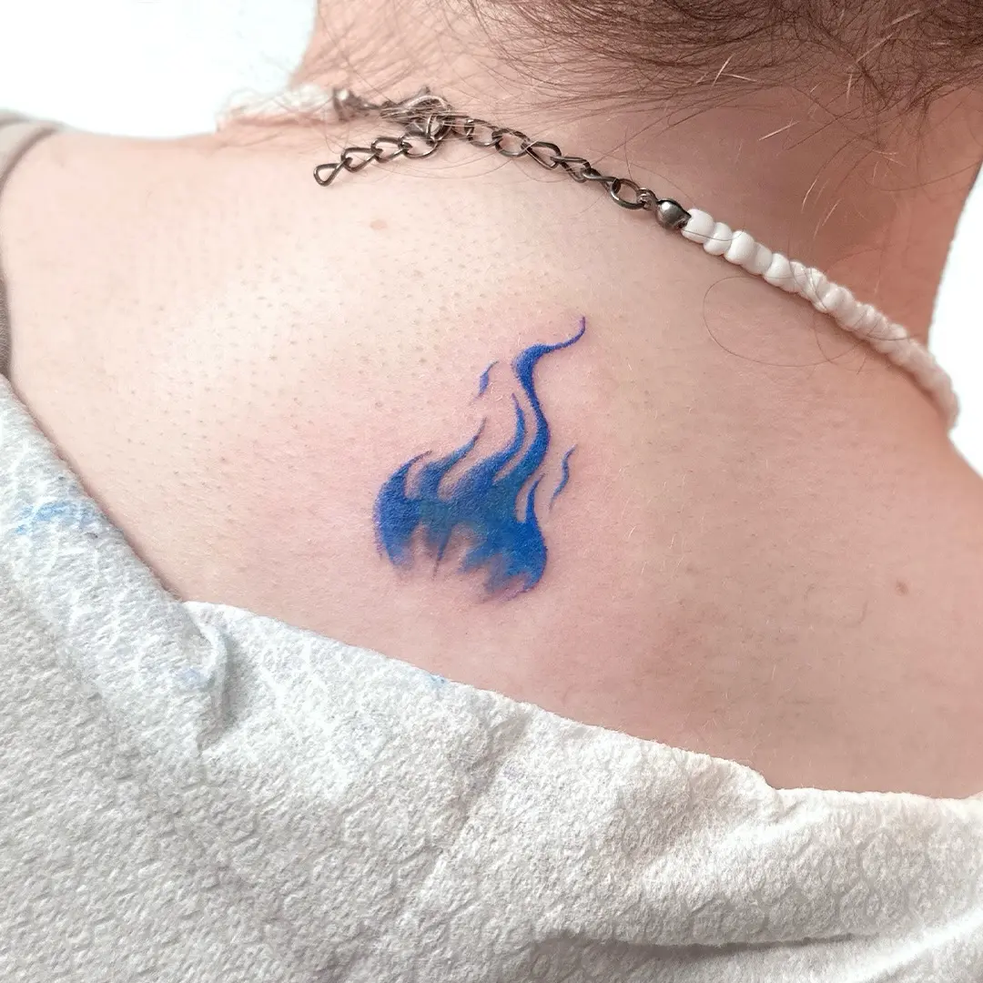 Unique blue flame tattoo on the back
