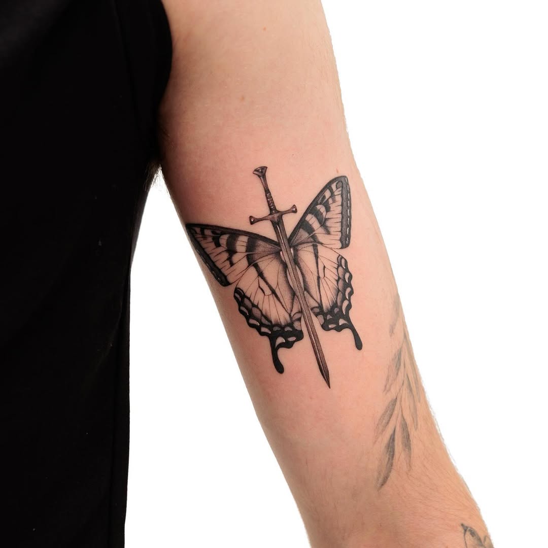 Intricate butterfly dagger tattoo blending beauty and strength